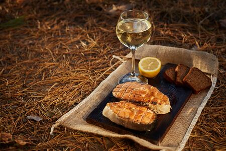 Cooked salmon steaks and ingredients on a old wooden board