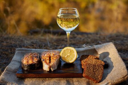 Cooked salmon steaks and ingredients on a old wooden boardの写真素材