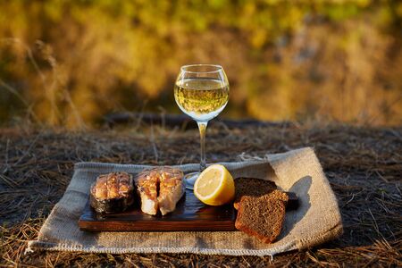 Cooked salmon steaks and ingredients on a old wooden boardの写真素材