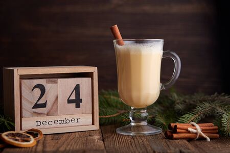 Traditional Homemade Winter Eggnog Cocktail with Whipped Cream and Cinnamon for Christmas Eve and Winter Holidays. Selective Focus. Copy Space. Toned image.の写真素材