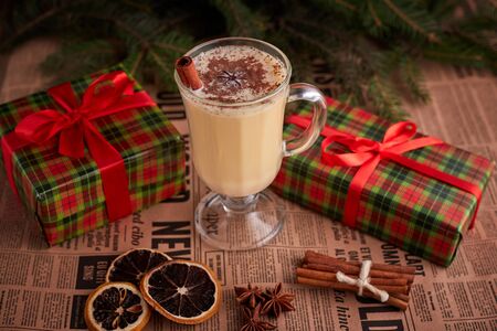 Traditional Homemade Winter Eggnog Cocktail with Whipped Cream and Cinnamon for Christmas Eve and Winter Holidays. Selective Focus. Copy Space. Toned image.の写真素材
