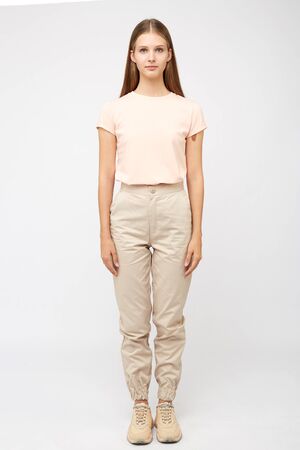 girl in beige cargo pants and a t-shirtの写真素材