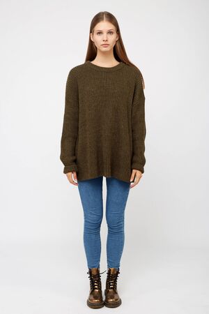 Girl dressed in a khaki sweater and jeans.の写真素材