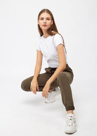 girl in khaki sweatpants and a t-shirtの写真素材