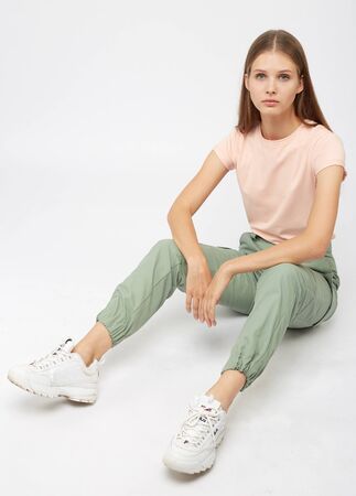 girl in green cargo pants and a t-shirtの写真素材