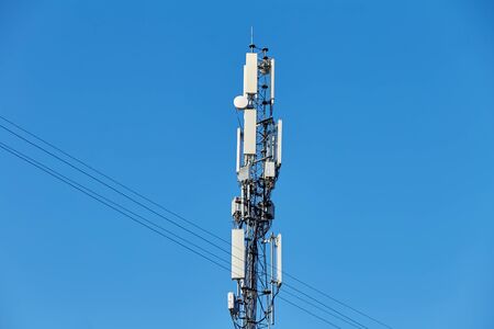 Technology on the top of the telecommunication GSM (5G,4G,3G) tower.Cellular phone antennas on a building roof.Telecommunication mast television antennas.Receiving and transmitting stationsの写真素材