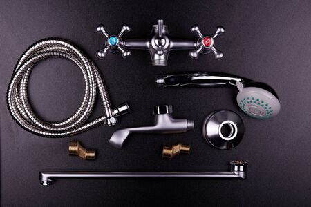 Plumbing tools on black background. Sanitary engineering