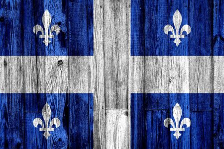 Quebec flag painted on wooden background, closeup.の写真素材