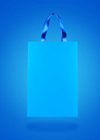 Blue paper shopping bag background.の写真素材