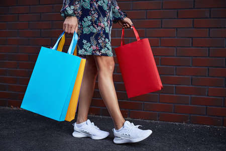 Black friday. Woman holding paper bags in her hand. Shopping mall.