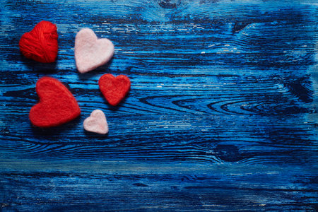 Decorative hearts on blue wooden backgroundの写真素材
