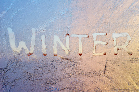 Evening Sun and Bright Blue Sky Through Frost Pattern on a Windowの写真素材