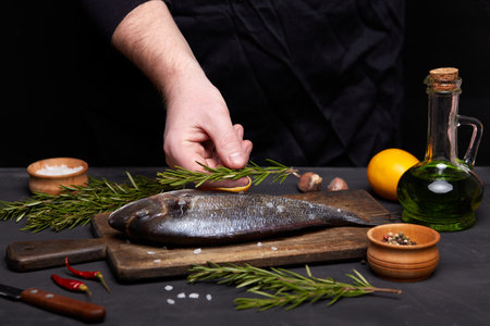 Process of cooking dorado fish with lemon and herbs.の写真素材