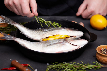 Process of cooking dorado fish with lemon and herbs.の写真素材