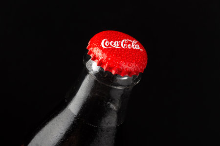 Kyiv, Ukraine- March 20, 2021: Coca-Cola Classic in a glass bottle on black background.のeditorial素材