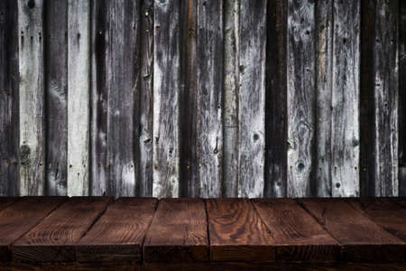 Scene creator. Mockup. Empty wooden deck table with dark wooden wall background.の写真素材