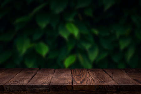Scene creator. Mockup. Empty wooden deck table with summer bokeh background.の写真素材