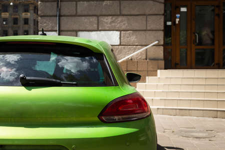 Back window of green car parked on the street in summer sunny day, rear view. Mock-up for sticker or decalsの写真素材