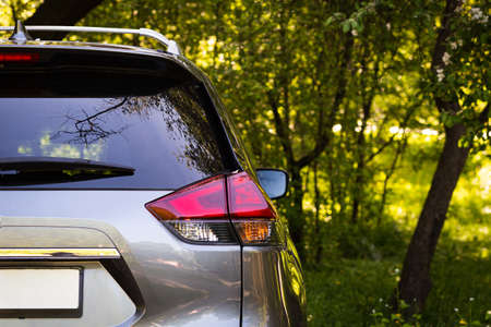 Back window of gray car parked on the street in summer sunny day, rear view. Mock-up for sticker or decalsの写真素材