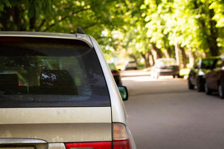 Back window of gray car parked on the street in summer sunny day, rear view. Mock-up for sticker or decalsの写真素材