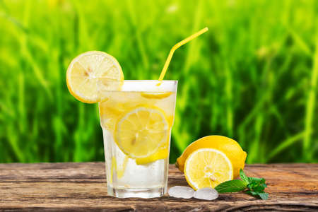 Natural lemonade with mint and fresh fruit on wooden table.の写真素材