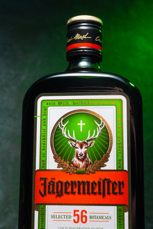 Ukraine, Poltava - July 11, 2022: Bottle of Jagermeister, German digestif made with 56 herbs and spices. bottle in green smokeのeditorial素材
