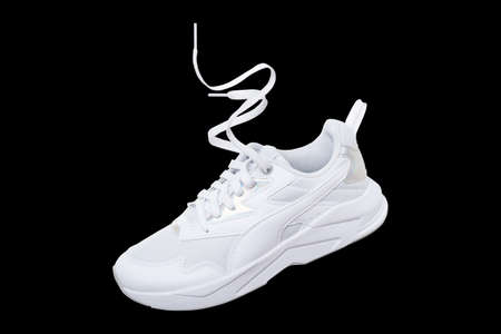 White flying sneakers isolated on black backgroundの写真素材