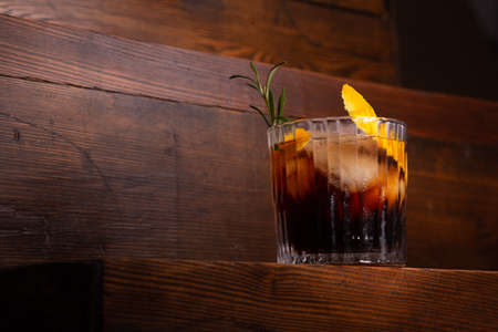 Whiskey with cola on dark wooden board.の写真素材