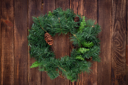 Christmas wreath on wooden background. Mock up. greeting card.の写真素材