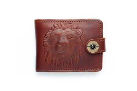 Brown leather wallet on a button on a white background, lion print. top viewの写真素材