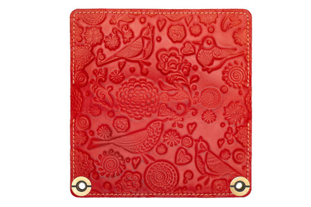 Big red leather wallet on a button on a white background, birds print. top viewの写真素材