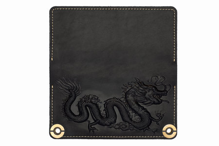 Big black leather wallet on a button on a white background, dragon print. top viewの写真素材