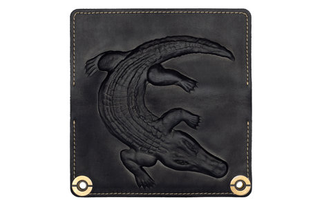Big black leather wallet on a button on a white background, crocodile print. top viewの写真素材
