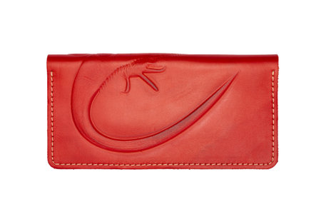 Big red leather wallet on a button on a white background, iguana print. top viewの写真素材