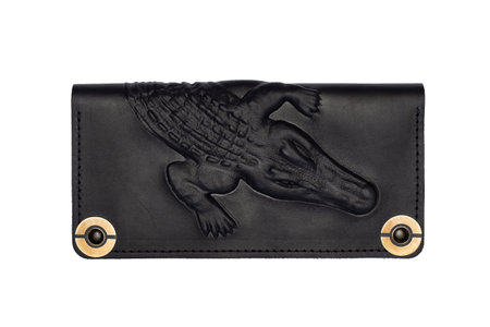 Big black leather wallet on a button on a white background, crocodile print. top viewの写真素材