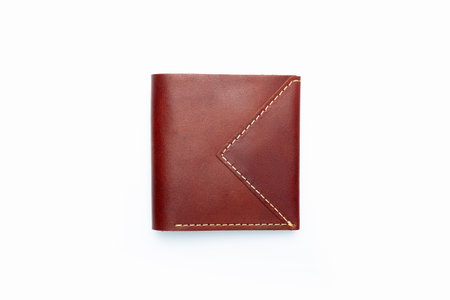 Small brown leather wallet on a button on a white background. top viewの写真素材
