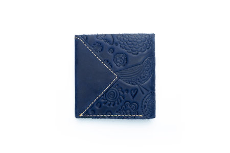 Small blue leather wallet on a button on a white background, birds print. top viewの写真素材