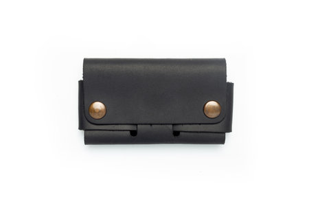 Small black leather wallet on a button on a white background. top viewの写真素材