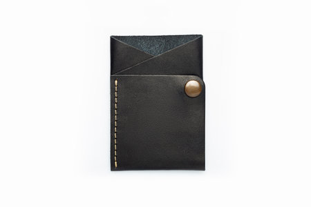 Black leather wallet on a button on a white background. cardholder. top viewの写真素材