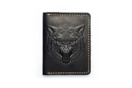 Black leather wallet on a button on a white background, wolf print. top viewの写真素材