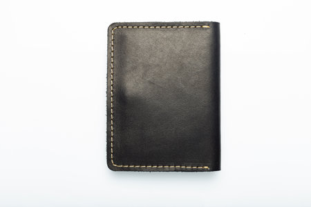 Black leather wallet on a button on a white background, wolf print. top viewの写真素材