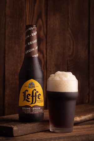 POLTAVA, UKRAINE - September 16, 2022: Bottle and glass of Belgian Leffe Bruin beerのeditorial素材