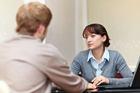 Good looking boss talking to her employeeの写真素材