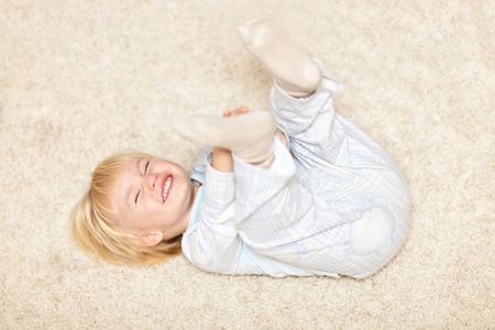 Cute little boy smiling and playingの写真素材