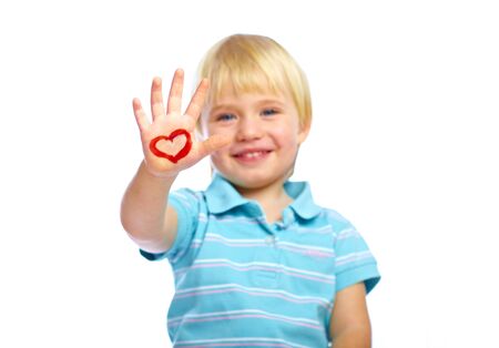 Happy kid with painted heart shape on his handの写真素材