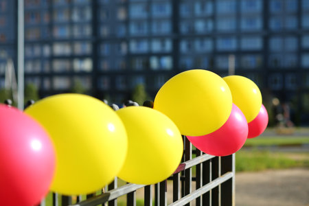 <p>Colorful row of pink and yellow air balloons used as outdoor decoration</p>の写真素材