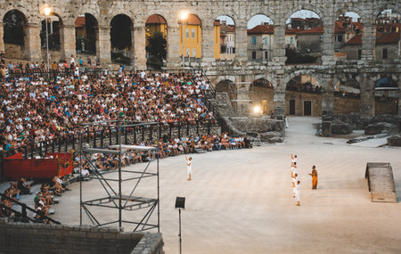 Audience watching gladiator show at Pula Roman amphitheaterの写真素材