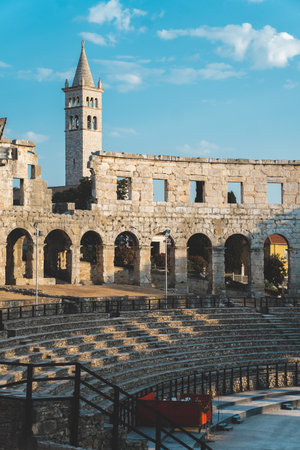 View inside the ancient Roman Arena in Pula with bell tower backgroundの写真素材