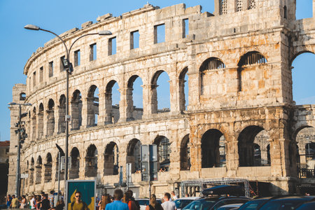 Pula Arena Roman Amphitheater in Croatia with tourists on a summer dayの写真素材