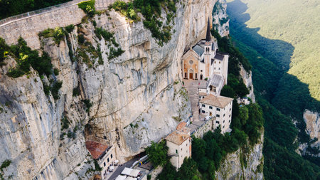 Aerial wide view of sanctuary church on dramatic cliff in Italyの写真素材